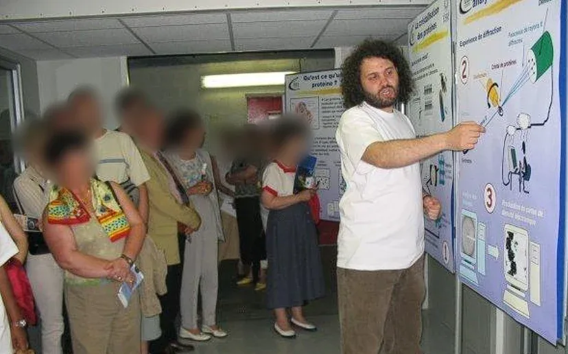 Explaining protein crystallography to visitors at an open day in Grenoble (visitors' faces blurred)